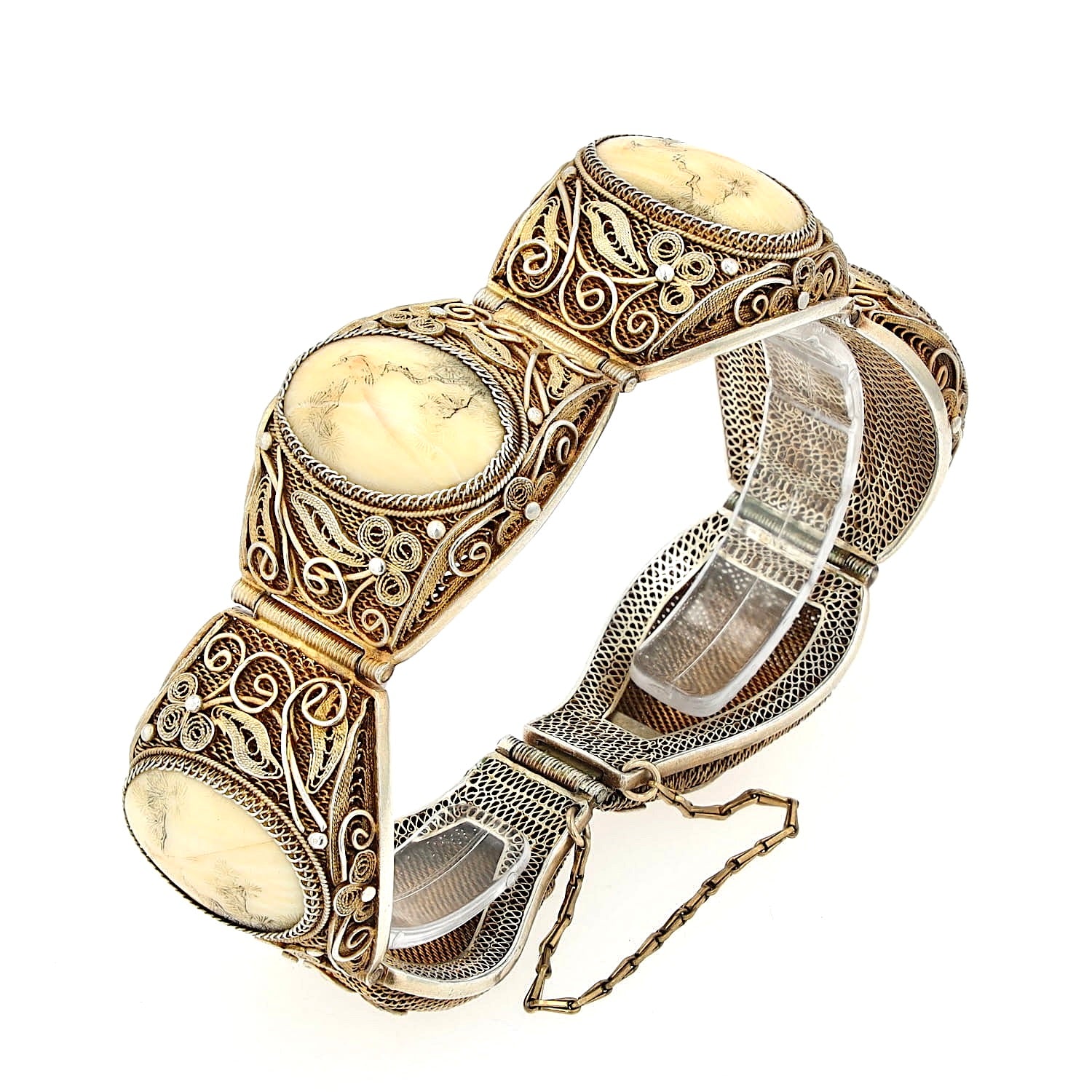 Chinese bracelet from around 1900 in silver, gold-plated with bone, standing on a plastic holder, closed and slightly turned to the left