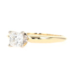 Solitaire ring in 750 yellow gold with a princess-cut diamond, lying frontally slightly turned to the left