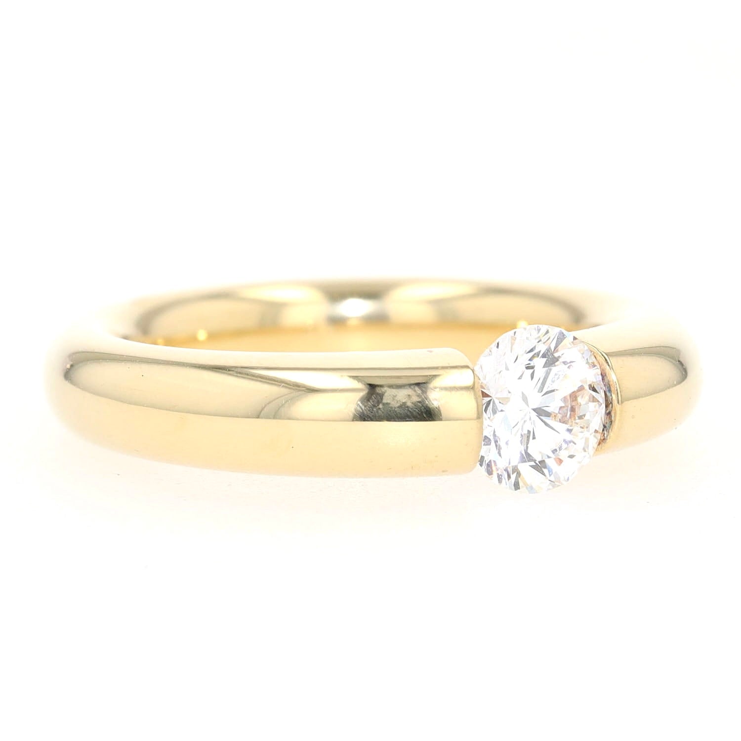 Niessing tension ring in 750 yellow gold with a brilliant approx. 1.0 ct, turned lying right