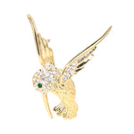 Gold-plated costume jewelry brooch in the shape of a hummingbird with glass stones, standing frontally
