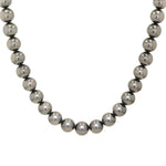 Faux pearl necklace on a steel cable with a magnetic lock made of 925 silver, hanging frontally