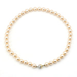 Shell bead necklace with gold-colored beads and a magnetic lock made of 585 yellow and white gold, closed horizontally