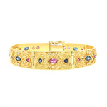 Armband in 750er Gelbgold mit Brillanten, Rubinen und blauen Saphiren, liegend geschlossen frontal